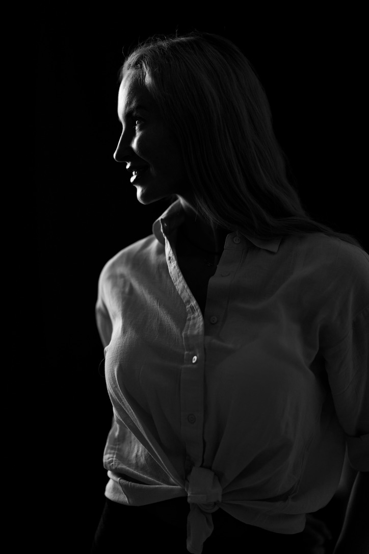 Profile silhouette with white shirt, dark background