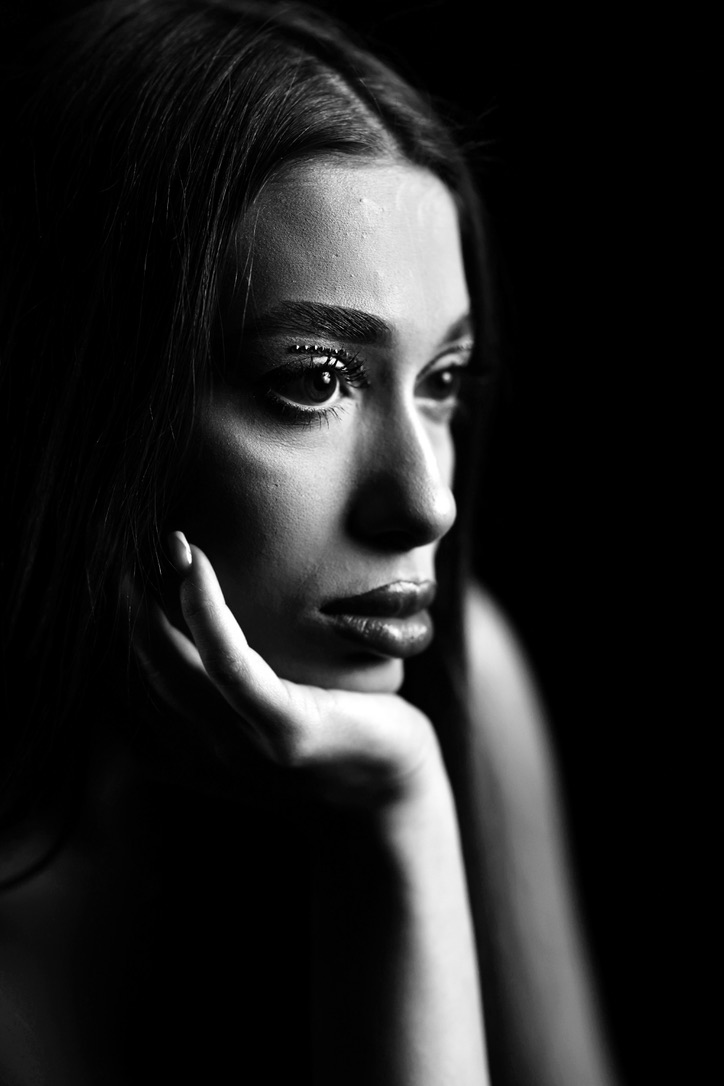 Black and white close-up portrait with dramatic lighting
